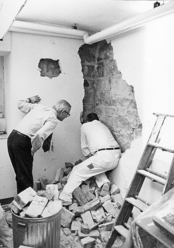Two men searching for the cornerstone.
