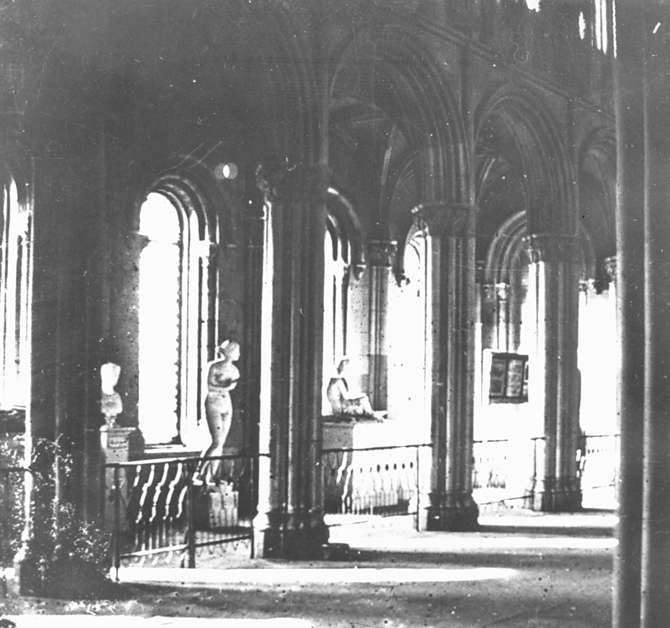 Interior image of the south-facing west range showing sculptures, columns, and decorative railings.