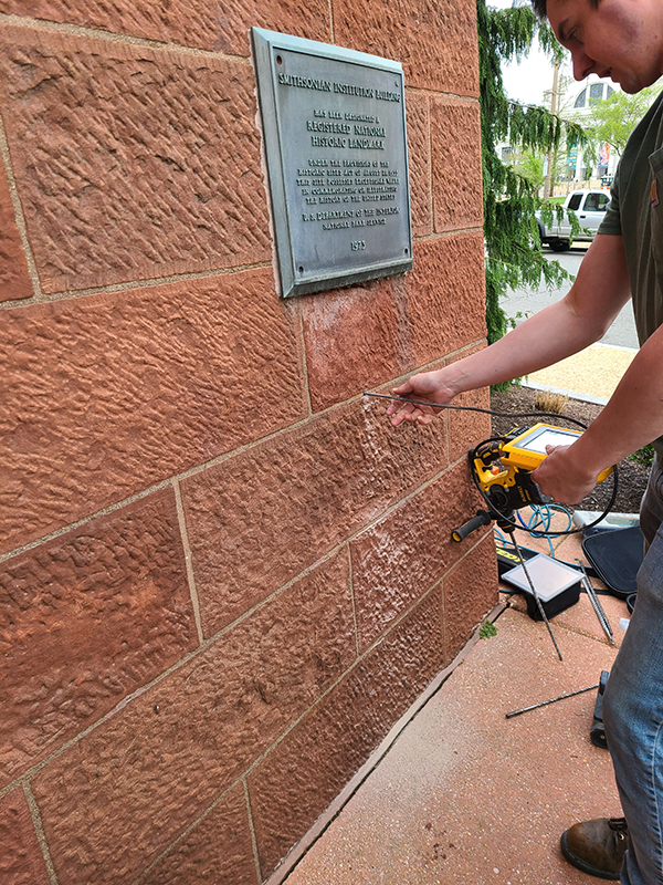 One hole was drilled in a mortar joint of the exterior masonry on the east side of the northeast corner of the East Wing and a fiber-optic videoscope was inserted.