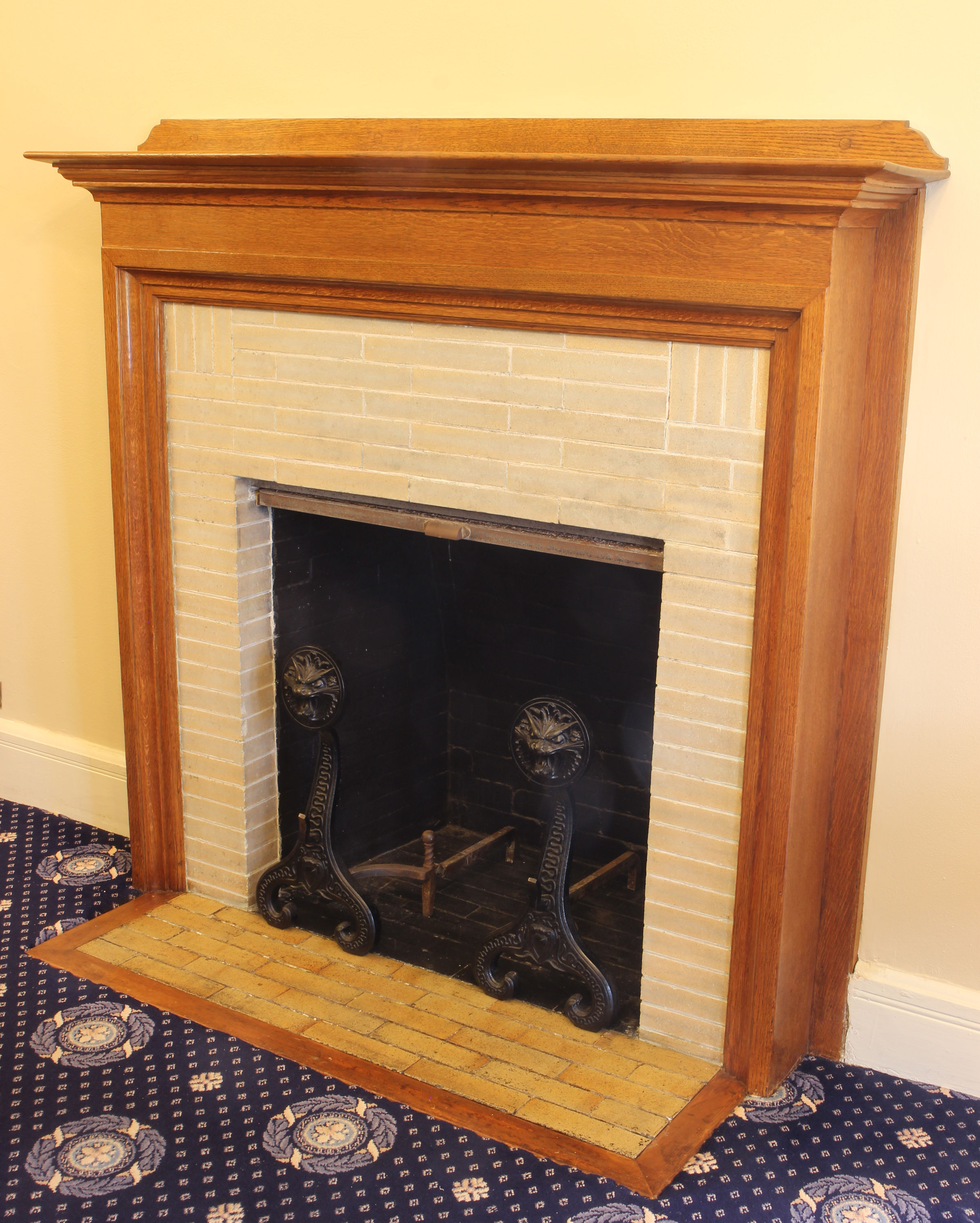 Image of the Art Room fireplace and wooden surround with tile inset.