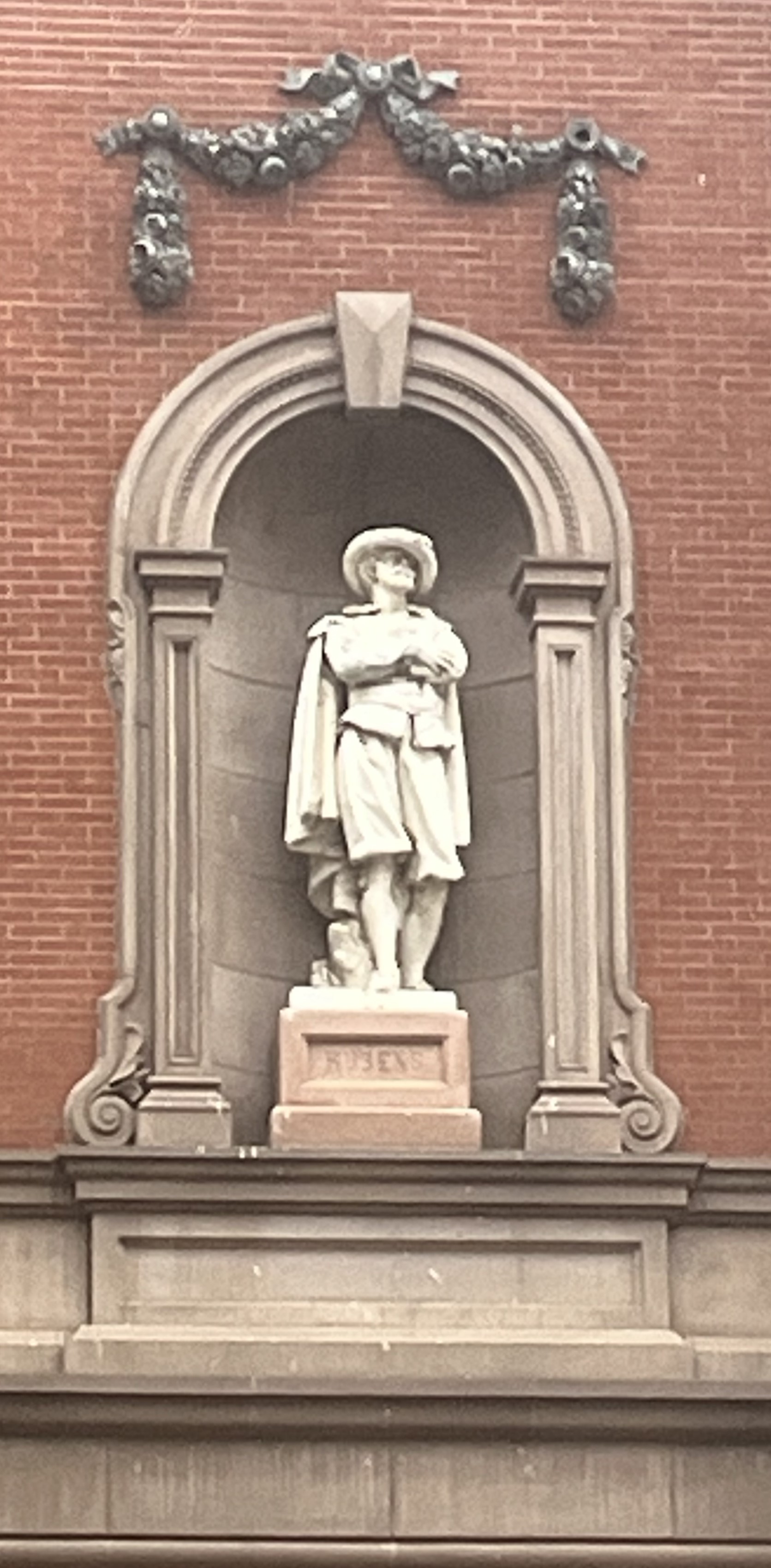 Statue in an exterior building niche.