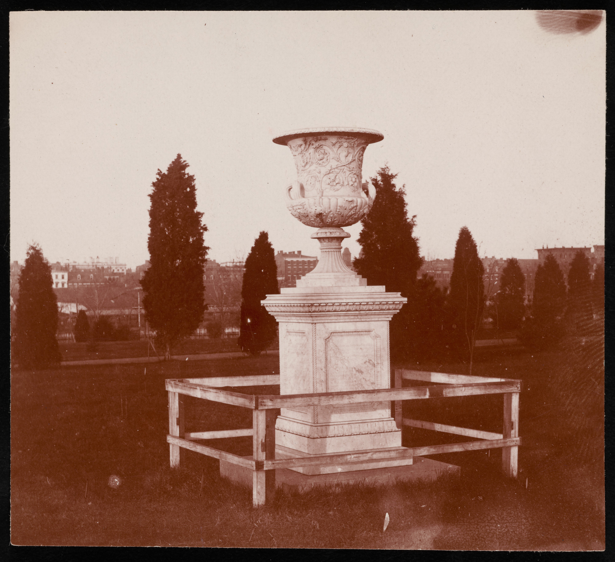 Historic image of the Downing Urn with an open field in the background.