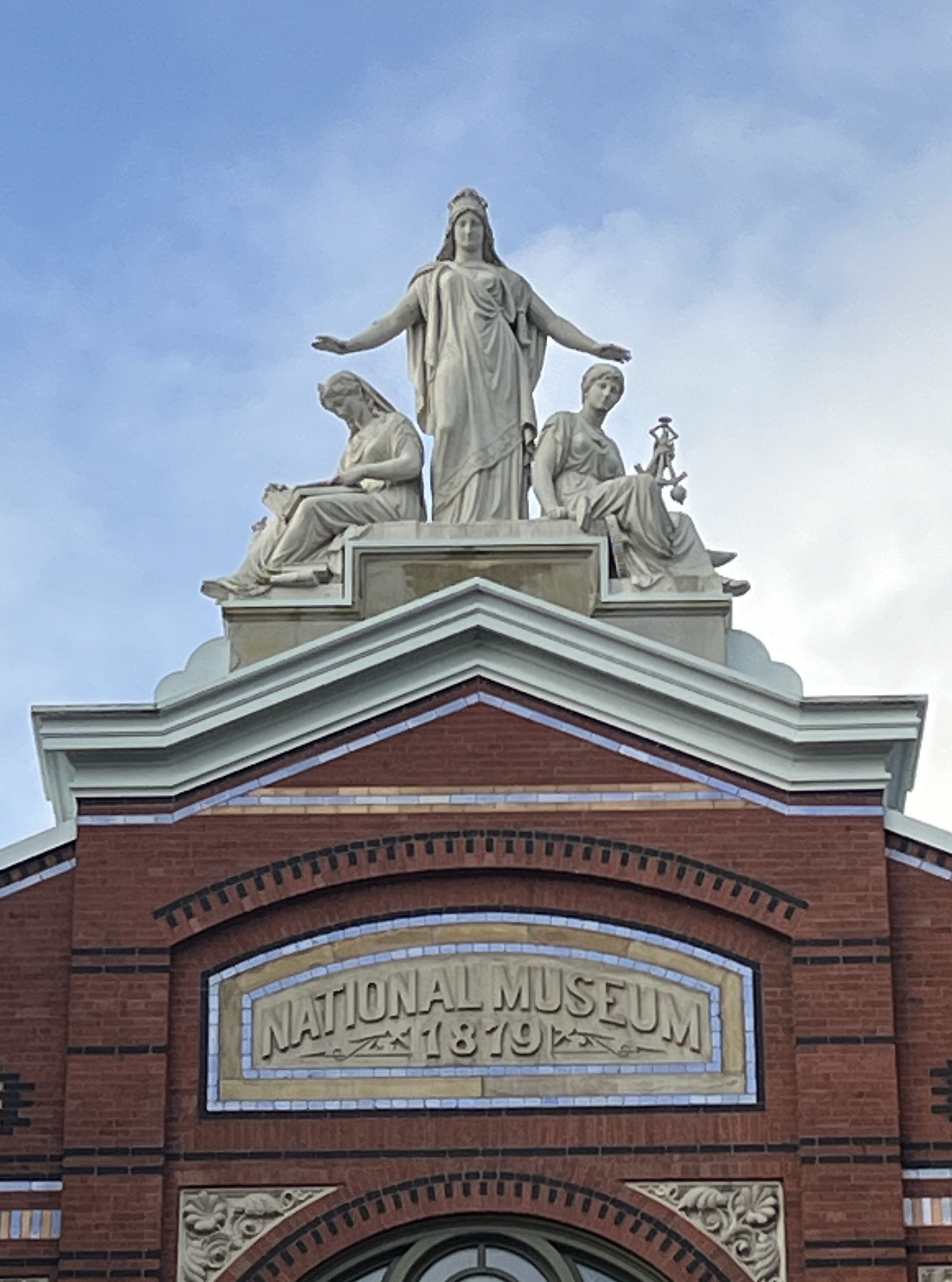 Roof peak closeup image showing a statue.