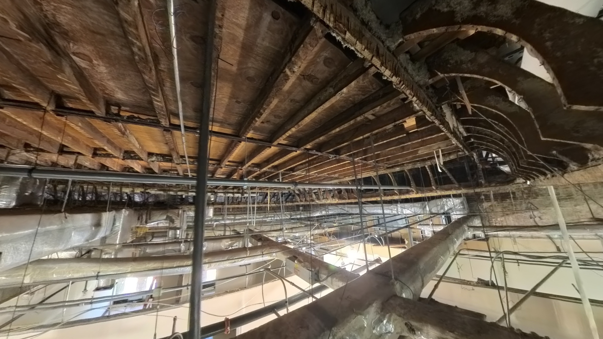 Photo of the Upper Great Hall historic wood framing. Profile of the tray ceiling curve visible at the right.