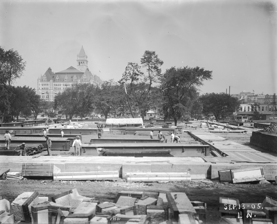 Image of the NMNH site in early stage of construction with building materials in groups on the ground.