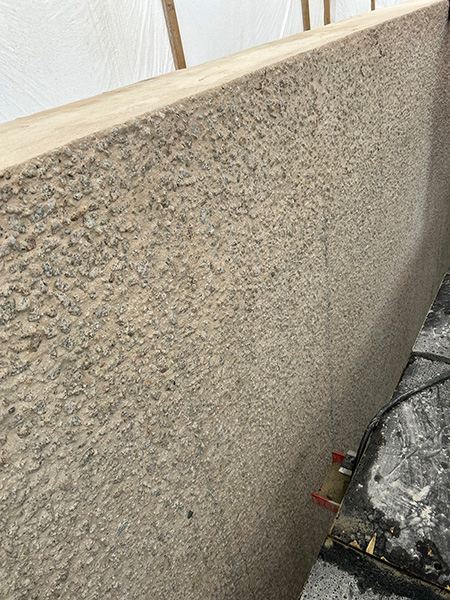 Image of concrete wall with equipment next to it.