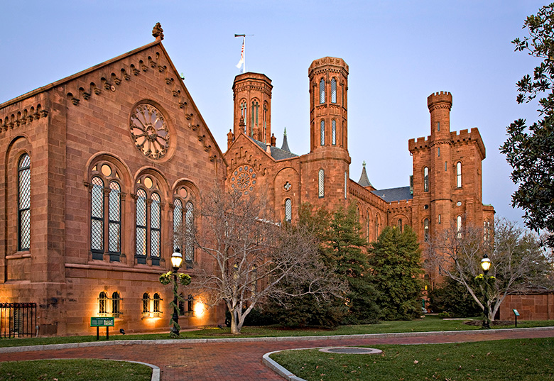 Image of the exterior of the Smithsonian Castle at dusk.