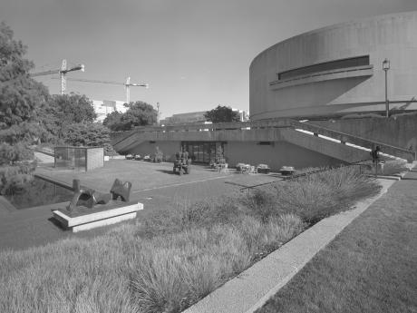 Image of the Hirshhorn Sculpture Garden with plantings, concrete walls, and scupture.
